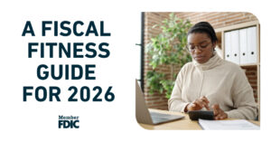Woman working at a laptop with the words Fiscal Fitness Guide. for 2026 to the left of her