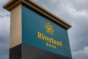 Blue and yellow Riverland Bank exterior signage